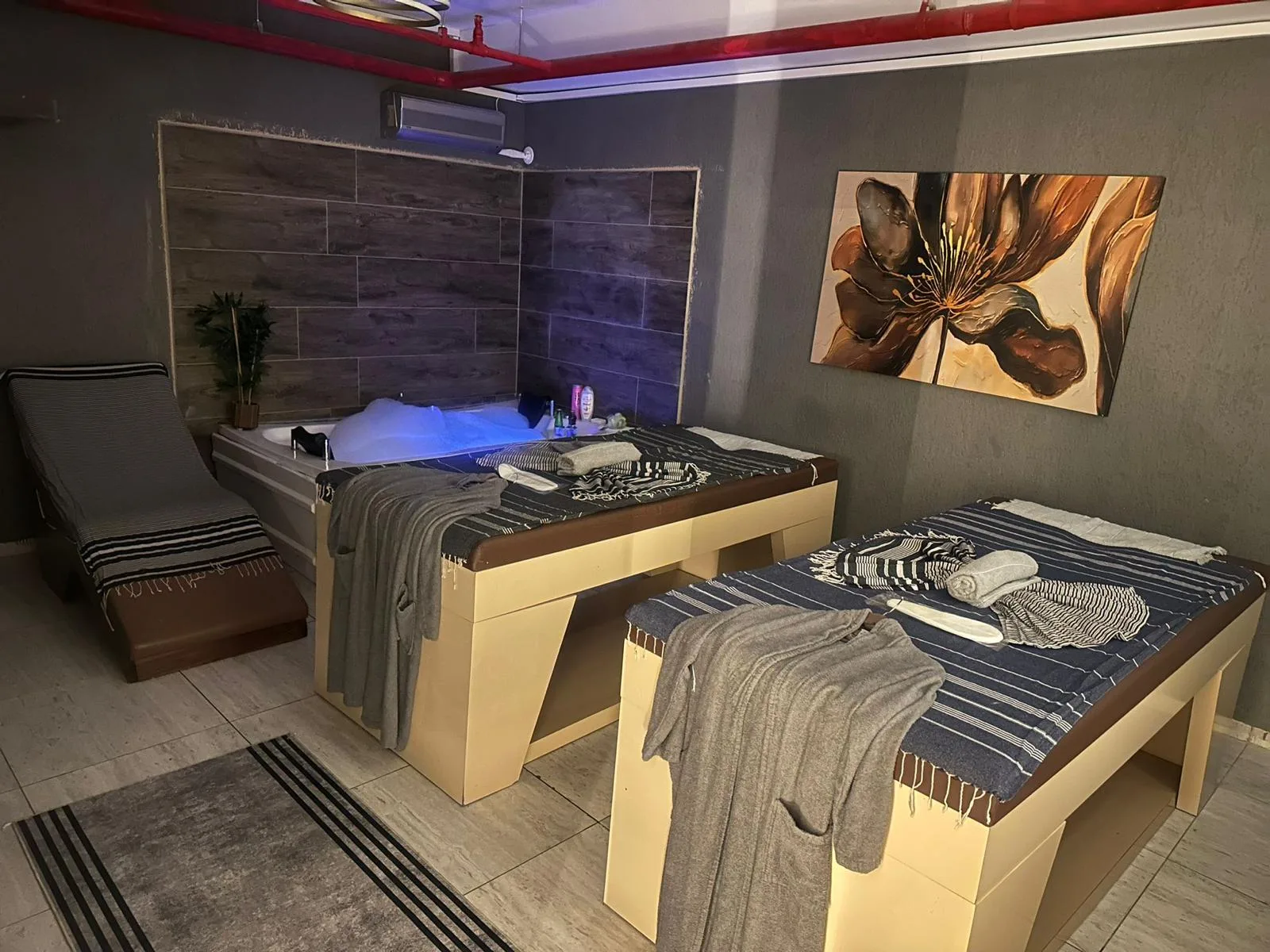 Spa Sparadise çift masaj odasında iki masaj yatağı ve jakuzi